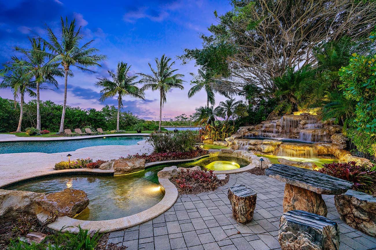 waterfall, spa, pool, and sunset